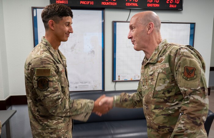 U.S. Air Force Chief of Staff Gen. David Allvin recognizes and coins Staff Sgt. Nathaniel Carbajal, 9th Operations Support Squadron survival evasion resistance and escape specialist, during a visit at Beale Air Force Base, California, May 28, 2025.