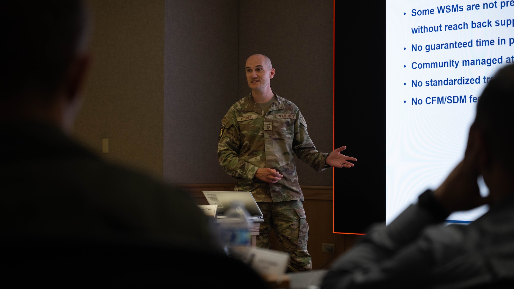 A U.S. Air Force Airman speaks at a summit conference.