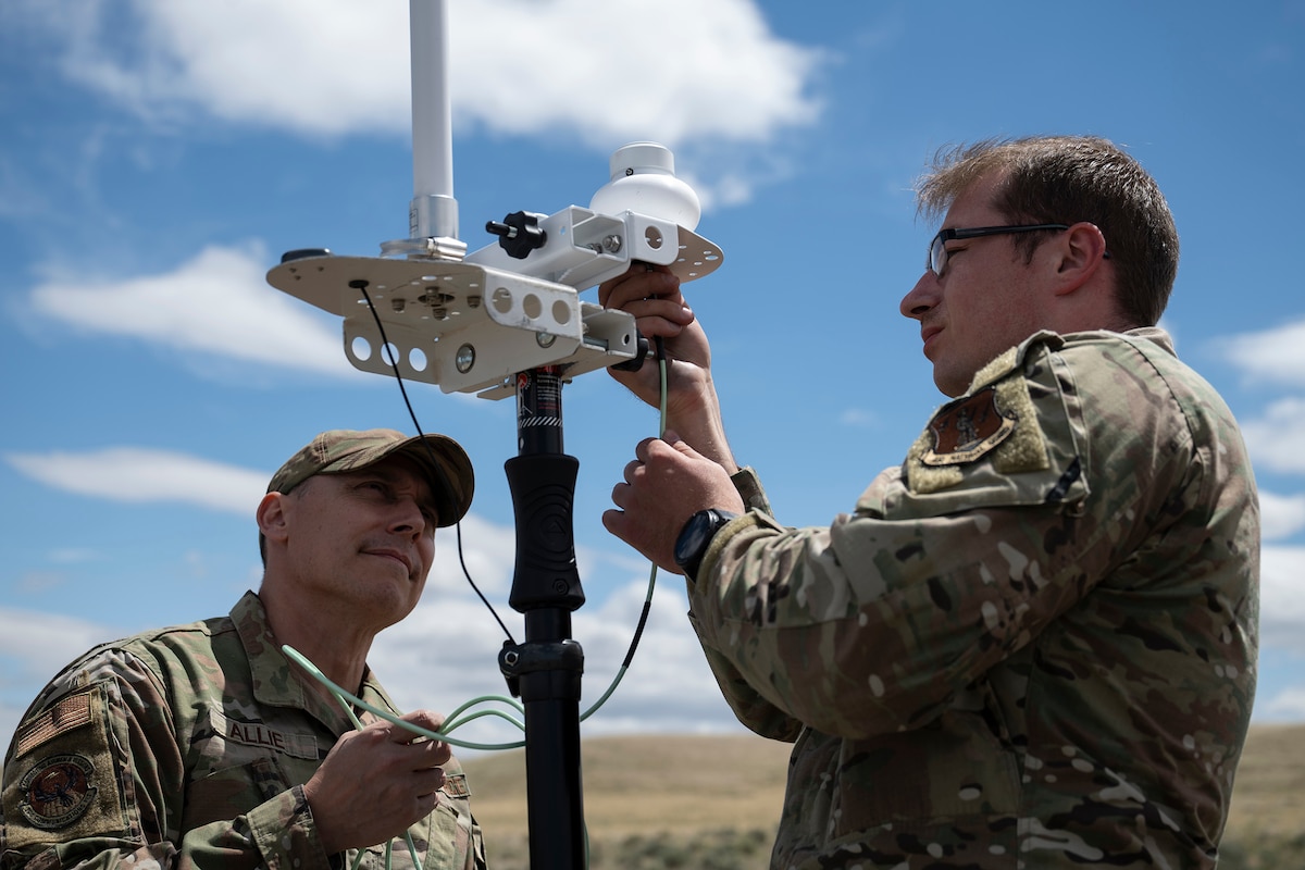 U.S. Air Force Staff Sgt. Nicholas Alie (left), radio shop apprentice with the 194th Communications Squadron, Washington Air National Guard, and Warrant Officer Jason Oakes, warfighter communications with the 194th CS, assemble a direction finding receiver during Exercise Phoenix Dawn 2025 at Saylor Creek Range near Mountain Home Air Force Base, Idaho, May 6, 2025.