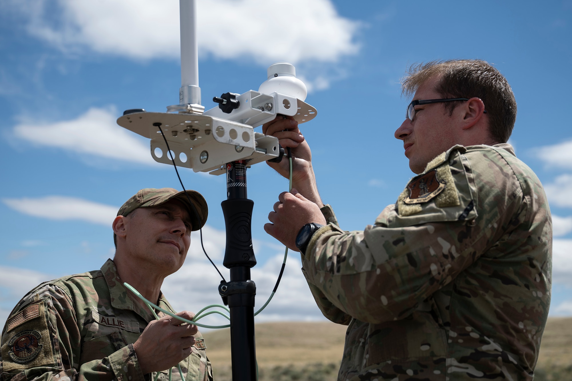 U.S. Air Force Staff Sgt. Nicholas Alie (left), radio shop apprentice with the 194th Communications Squadron, Washington Air National Guard, and Warrant Officer Jason Oakes, warfighter communications with the 194th CS, assemble a direction finding receiver during Exercise Phoenix Dawn 2025 at Saylor Creek Range near Mountain Home Air Force Base, Idaho, May 6, 2025.