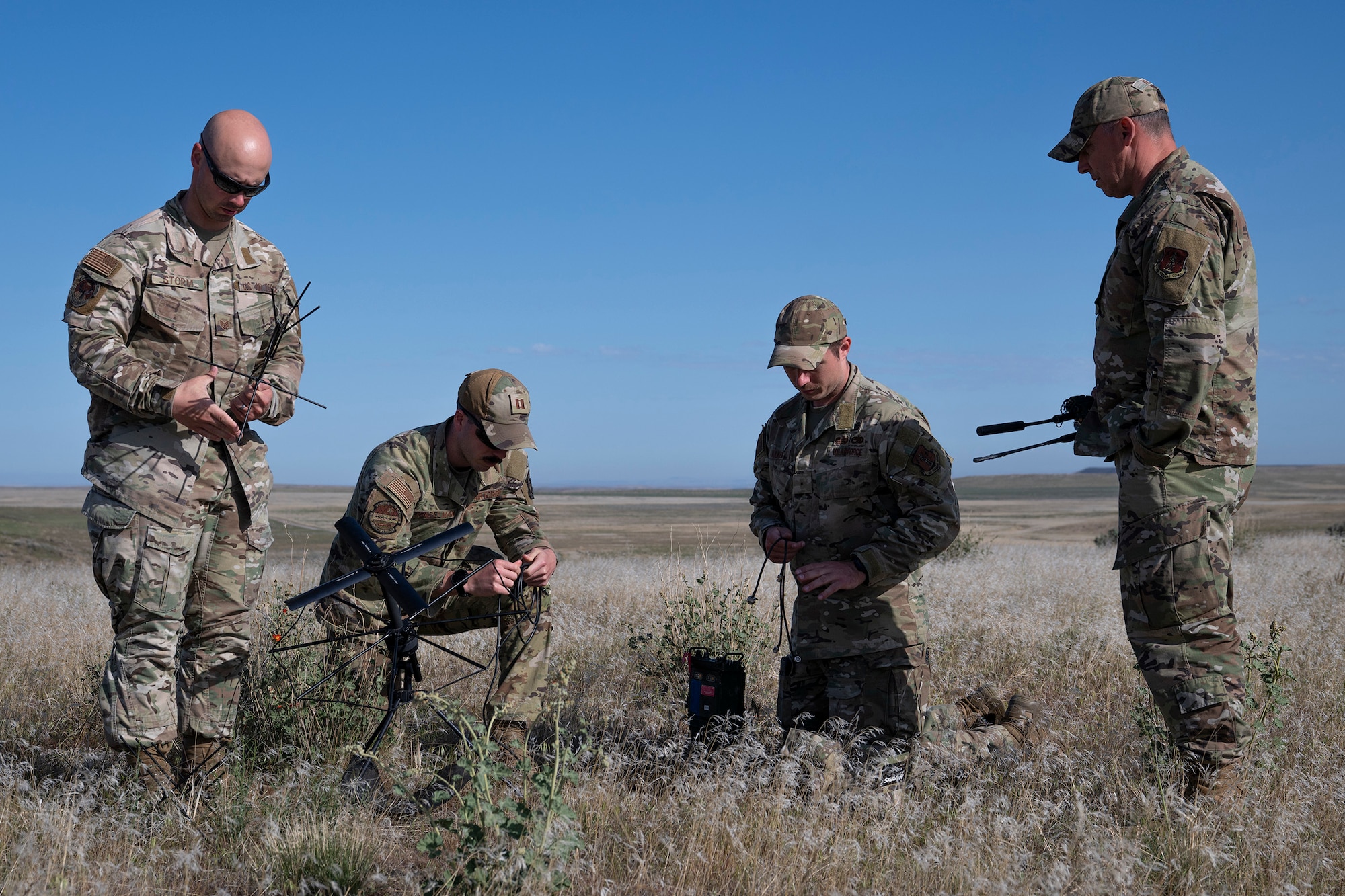 U.S. Air Force Warrant Officer Jason Oakes (second from right), warfighter communications with the 194th Communication Squadron, Washington Air National Guard, and fellow Airmen with the 194th Wing, assemble a Mobile User Objective System antenna during Exercise Phoenix Dawn 2025 at Saylor Creek Range near Mountain Home Air Force Base, Idaho, May 6, 2025.