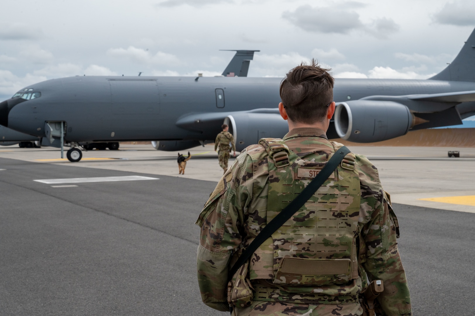 Airman sweeps the flightline.