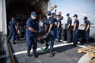 U.S. Coast Guard Cutter Thetis crew members offload illicit drugs seized during a patrol in the Eastern Pacific Ocean.