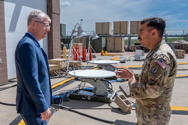 Secretary of the Air Force Troy Meink (left) gets a briefing from U.S. Space Force Capt. Nicholas Bacogiannis (right) of Mission Delta 3 (Electromagnetic Warfare) at Peterson Space Force Base, Colorado, May 28, 2025. Space Operations Command Guardians and Airmen demonstrated their combat readiness and warrior ethos, providing Meink with a deep dive into multiple critical mission areas, to include Space Domain Awareness; Electromagnetic Warfare; Missile Warning; Intelligence, Surveillance, Reconnaissance and Targeting; Orbital Warfare and Positioning, Navigation and Timing; as well as the critical mission support provided by the U.S. Air Force.  (U.S. Space Force photo by Dave Grim)