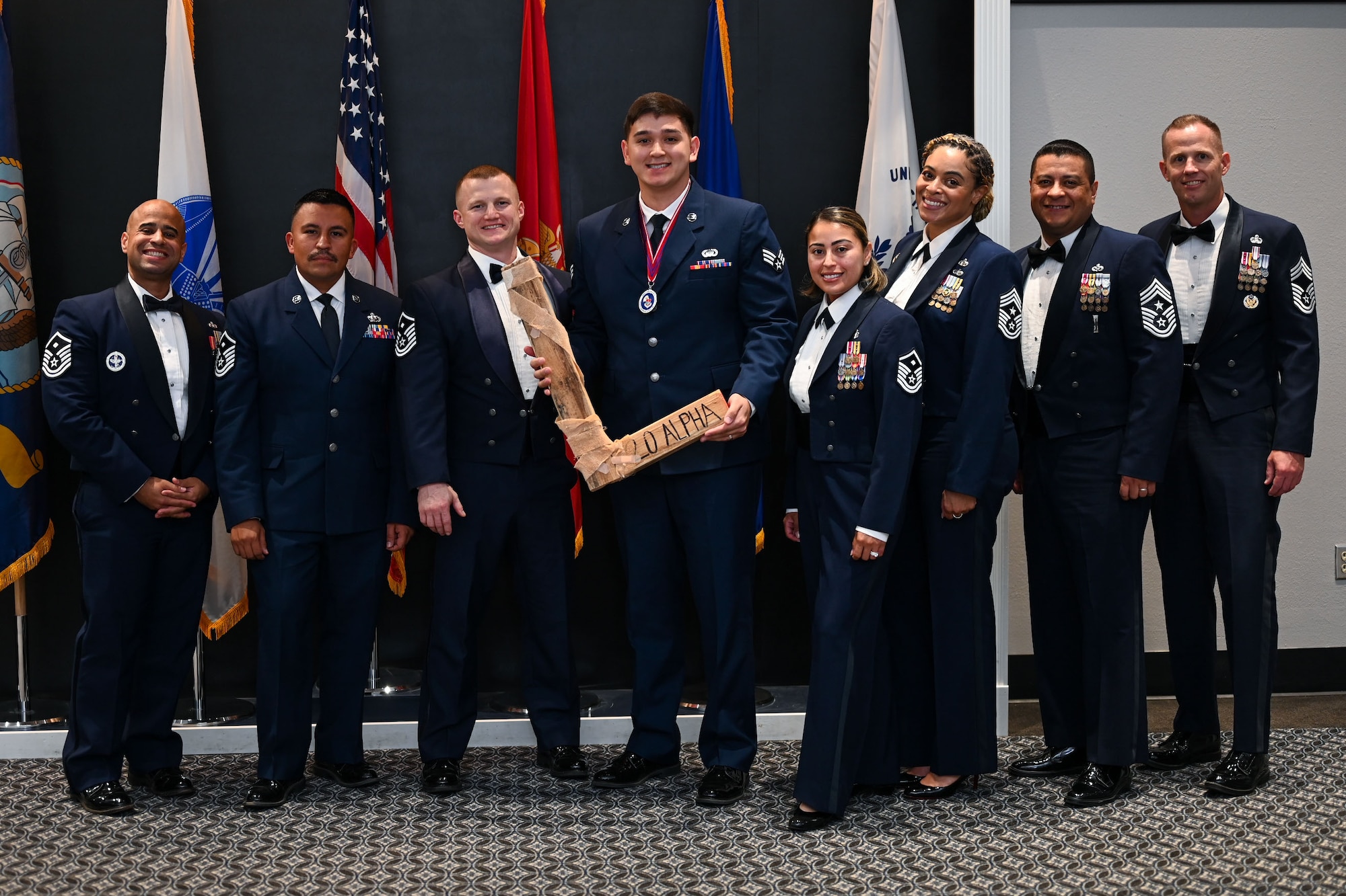 U.S. Air Force Senior Airman Cade Kennedy, Airman Leadership School Class 25-D class lead, takes the “L” from the Top 3 council, during the ALS Class 25-B graduation at the Powell Event Center, Goodfellow Air Force Base, Texas, May 22, 2025. Every ALS class plays a volleyball game with the first sergeants and the winning team presents the “L” to the losing team at graduation. (U.S. Air Force photo by Senior Airman Evelyn J. D’Errico)