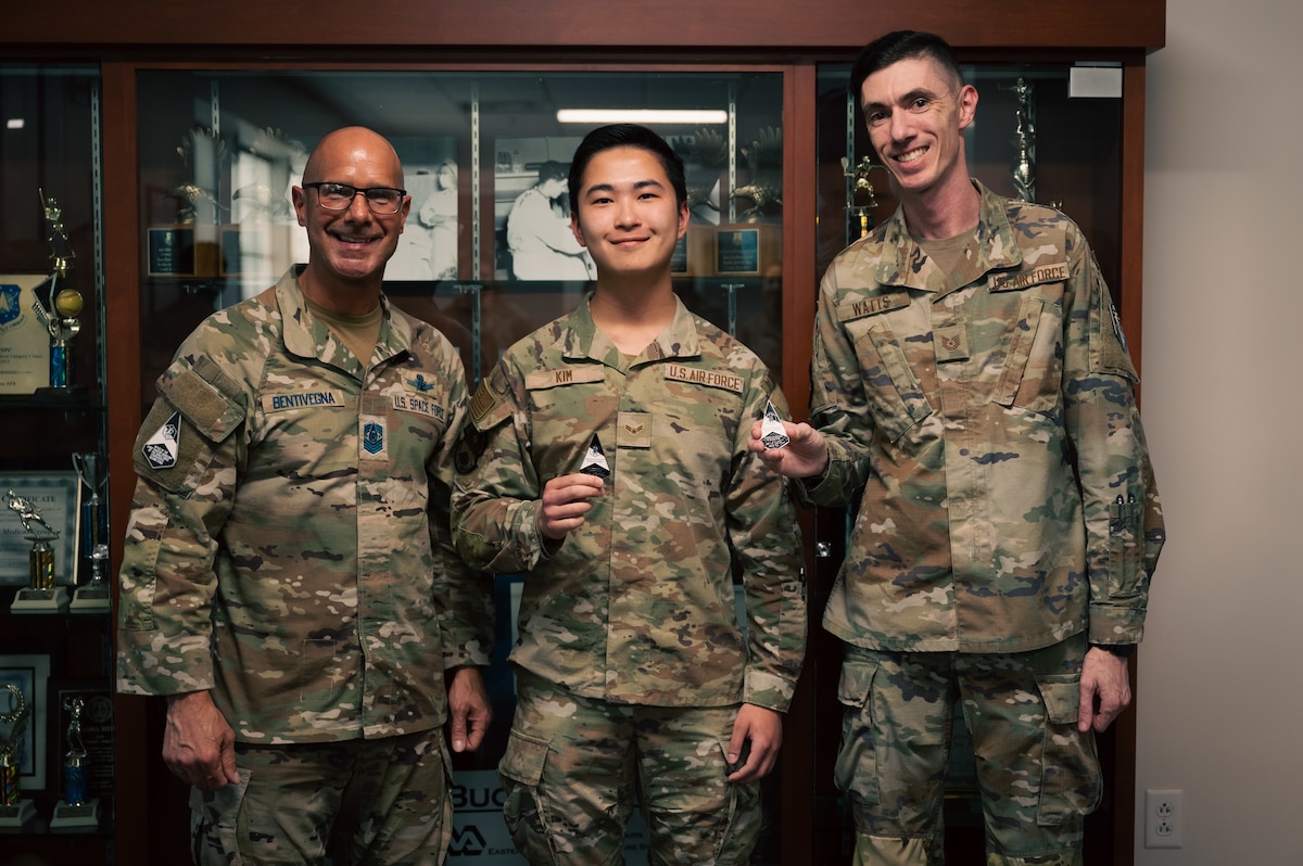 three men pose for a photo