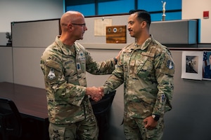 Two men shake hands
