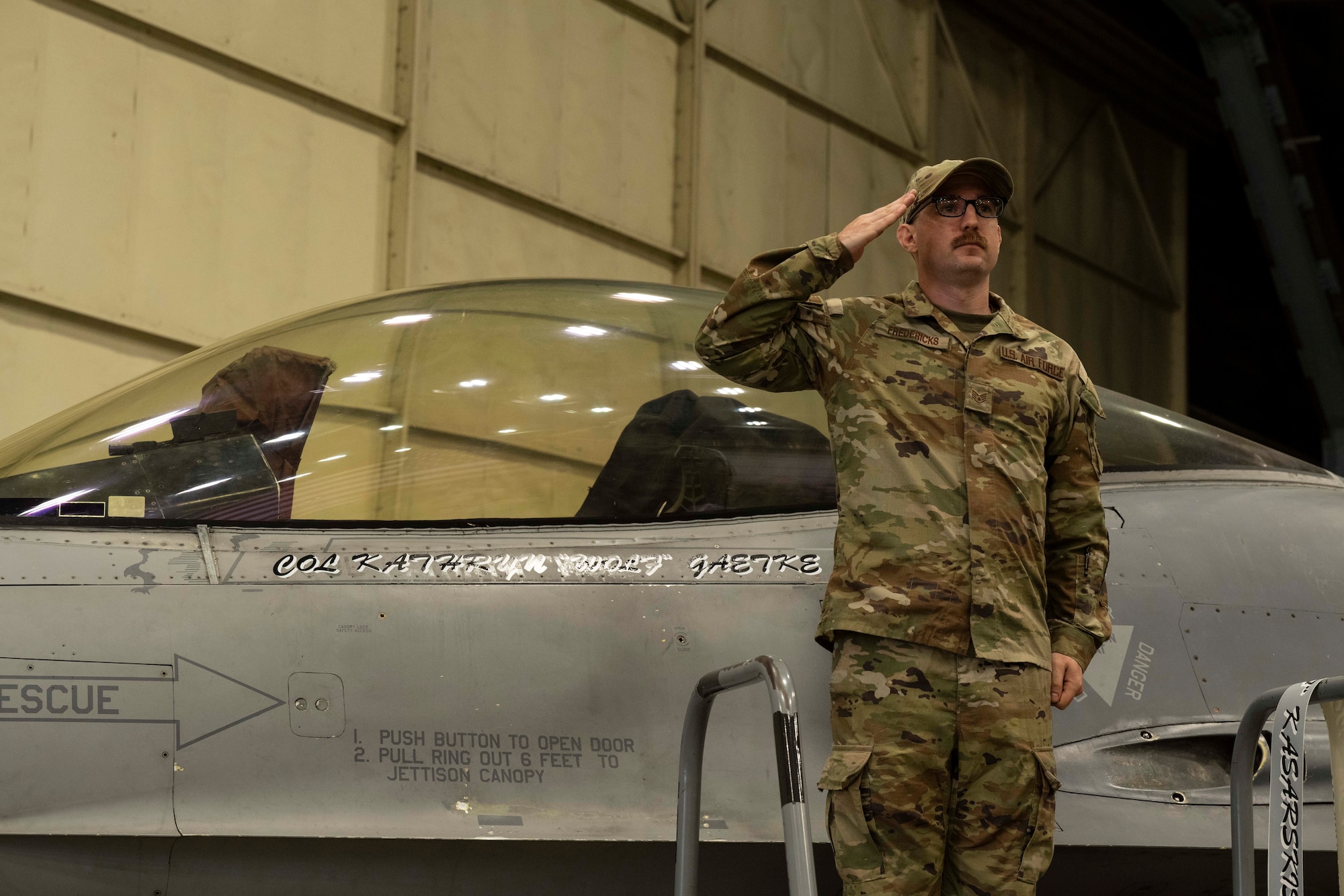 U.S. Air Force Staff Sgt. Ethan Fredericks, 35th Fighter Generation Squadron dedicated crew chief, unveils the new 8th Fighter Wing commander, Col. Kathryn Gaetke’s name on a U.S. Air Force F-16 Fighting Falcon during the 8th FW change of command ceremony at Kunsan Air Base, Republic of Korea, May 30, 2025.