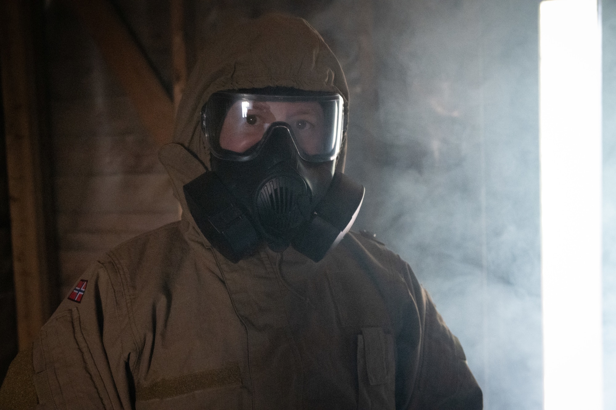 A U.S. Airman from the 426th Air Base Squadron wears a protective mask inside a gas chamber