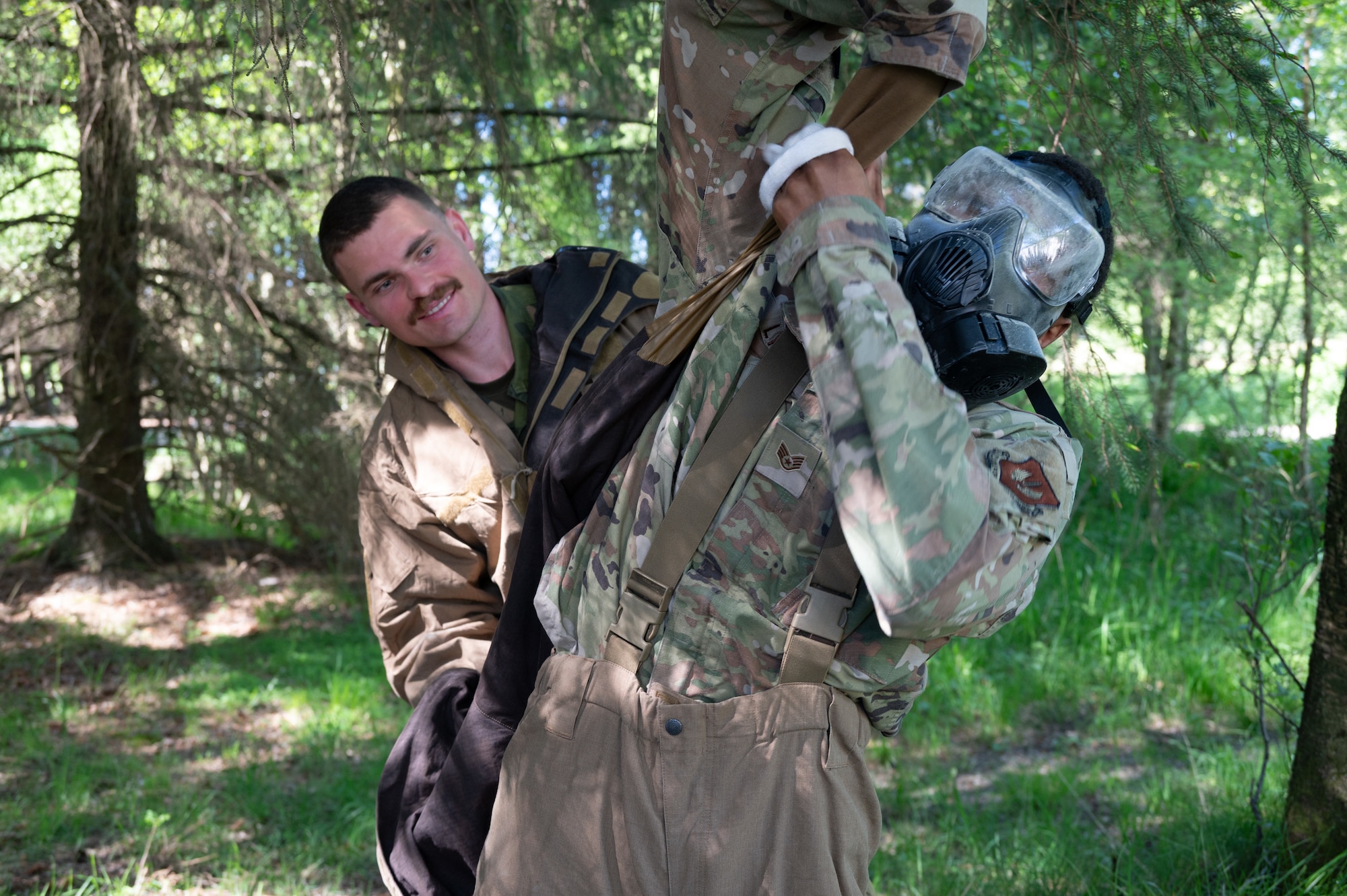Royal Norwegian Navy Leading Seaman Forland Magnus, a force protection instructor, assists a U.S. Airman