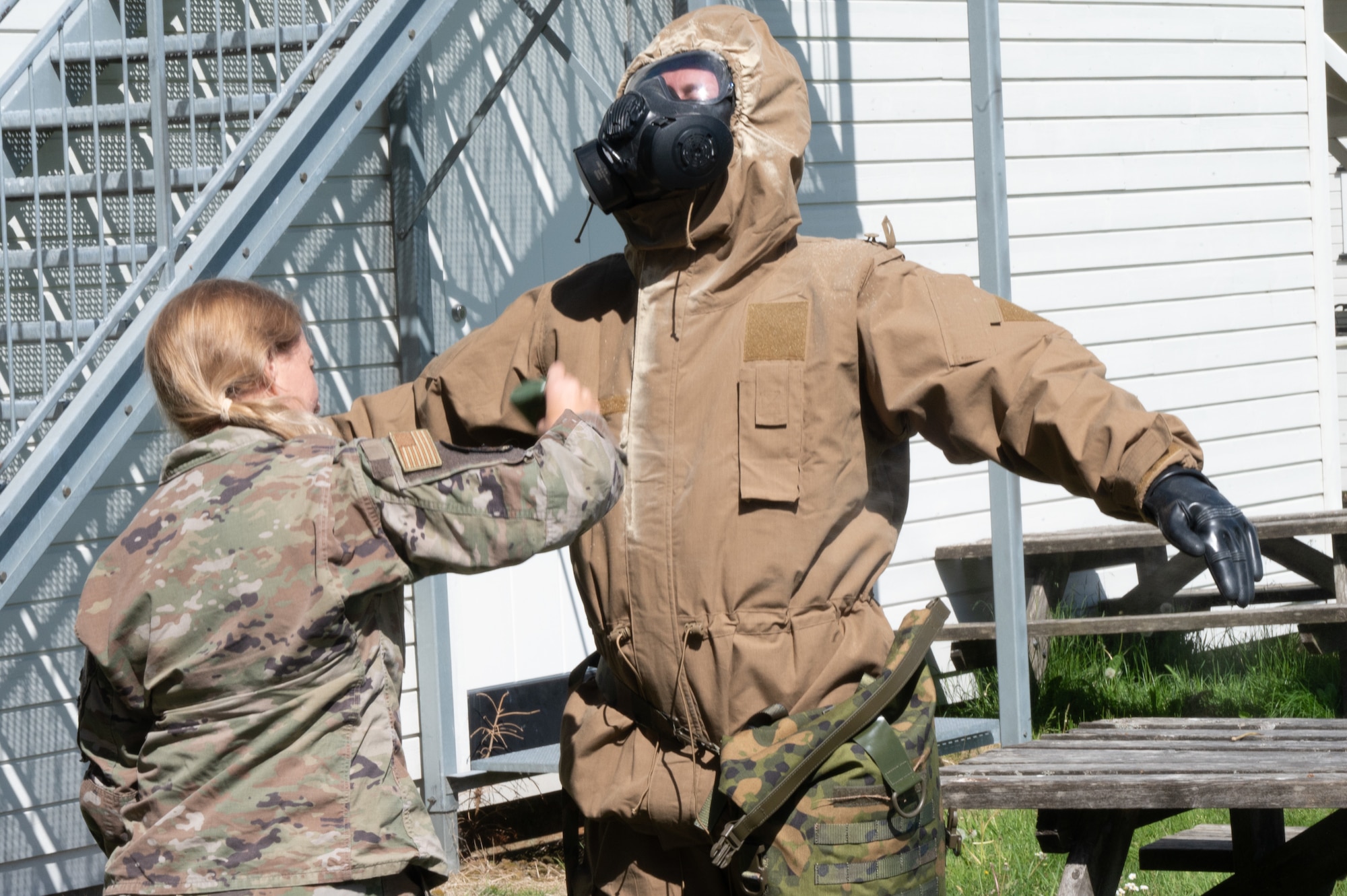 U.S. Airmen from the 426th Air Base Squadron conduct decontamination procedures following gas chamber exposure