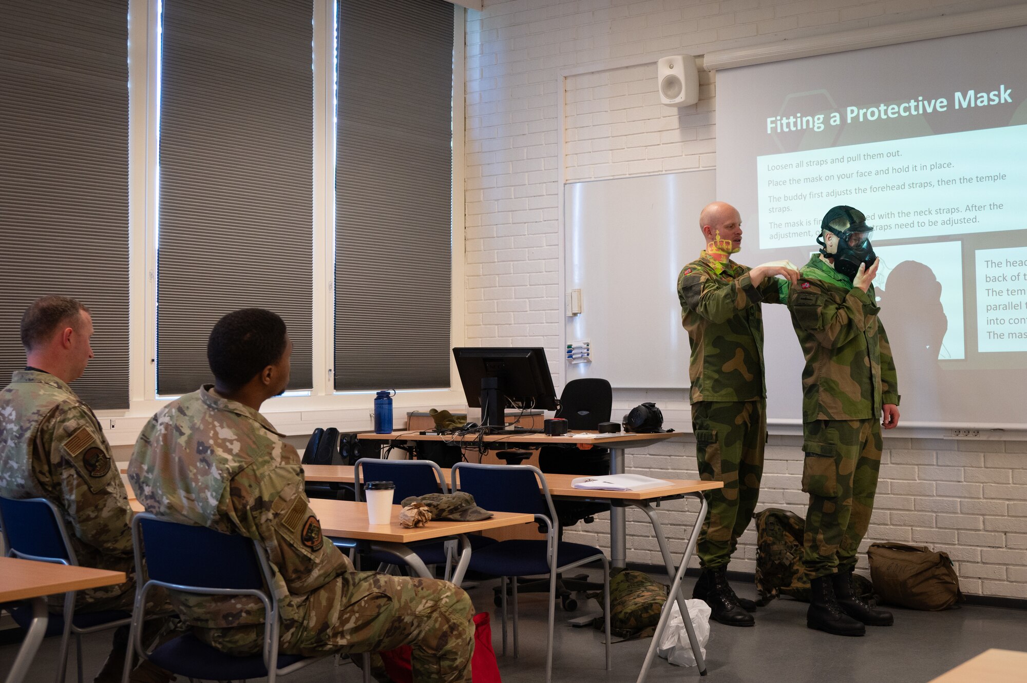Norwegian Navy instructors conduct Chemical, Biological, Radiological and Nuclear (CBRN) classroom training for U.S. Airmen from the 426th Air Base Squadron