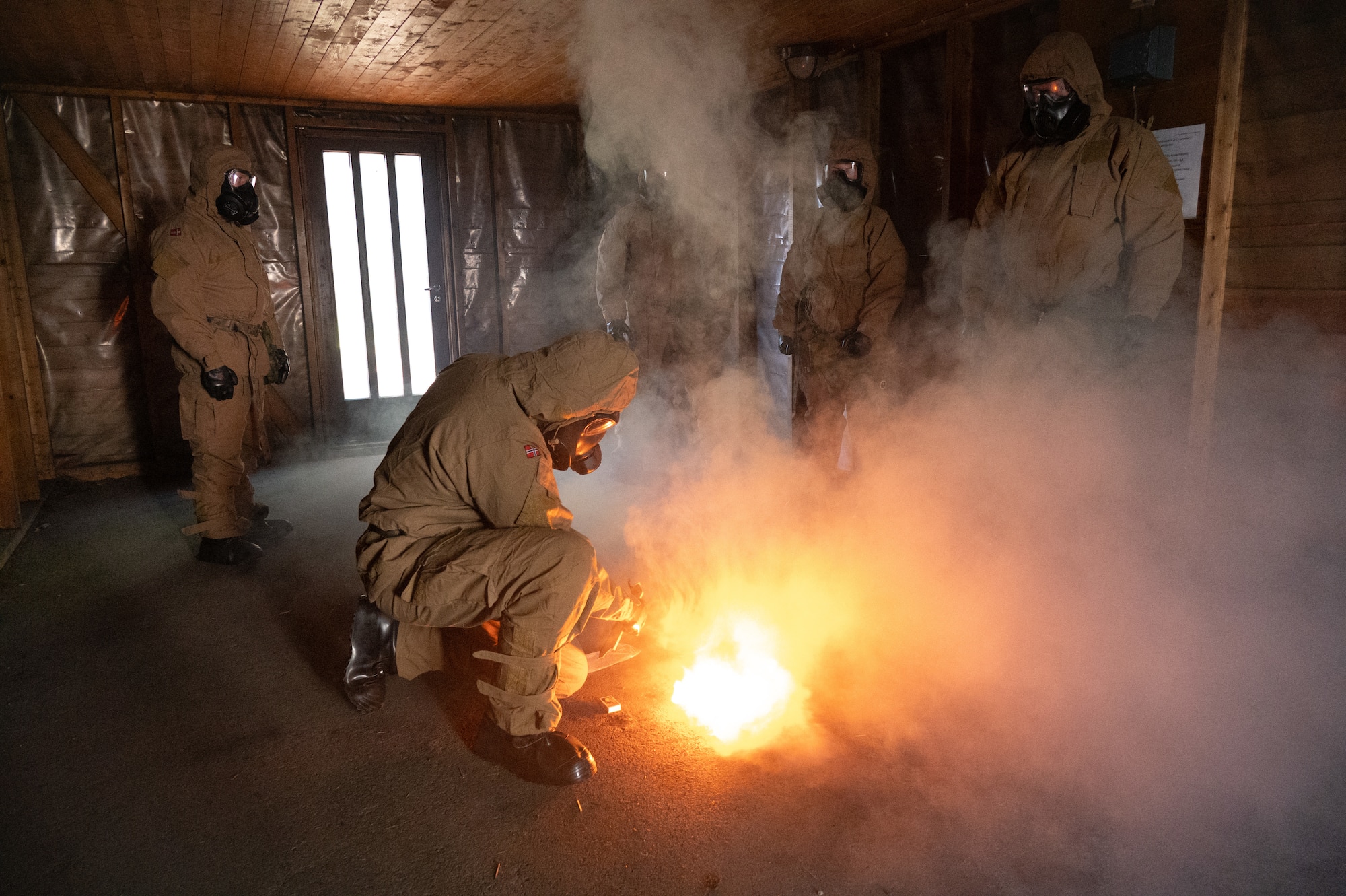 A Royal Norwegian Navy instructor ignites tear gas tablets
