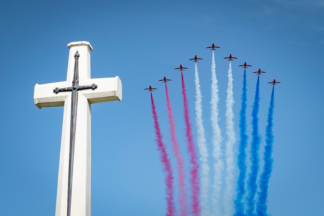 Participants in a Battle of Crete anniversary observance watch the Royal Air Force Aerobatic Team, known as the Red Arrows, at the Allied War Cemetery in Souda Bay, Crete, Greece, on May 24, 2025.