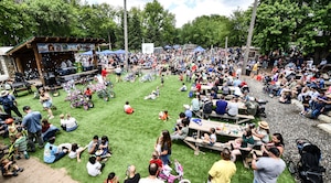 Service members and their families listens to music during Appreciation Day Picnic.