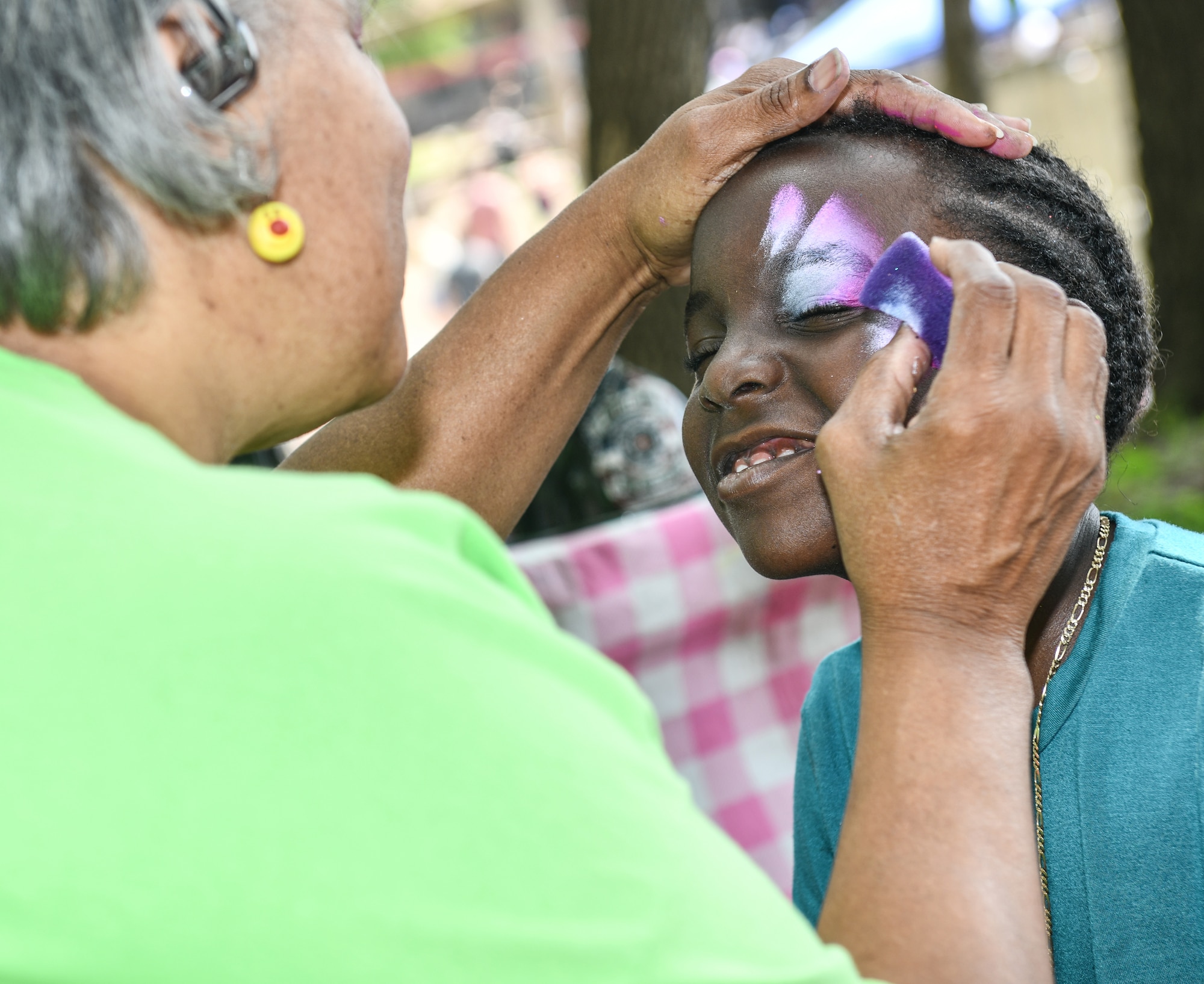 Child gets her face painted during Appreciation Day Picnic.