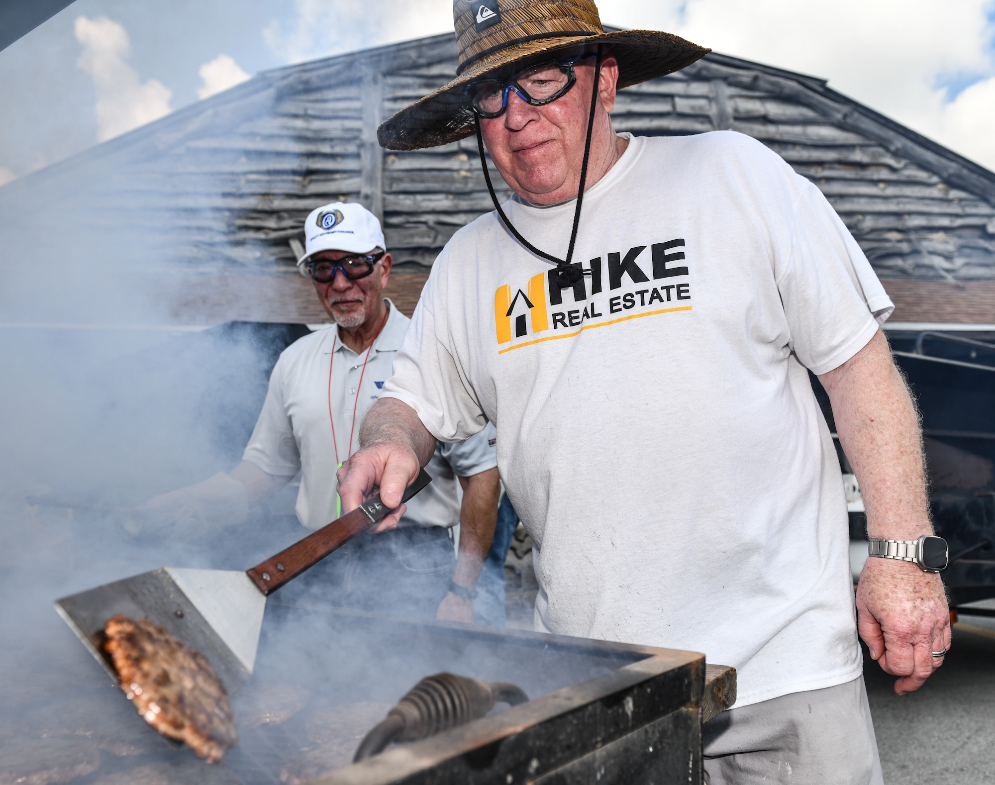 Bellevue, Nebraska city mayor flips burgers during Appreciation Day Picnic.