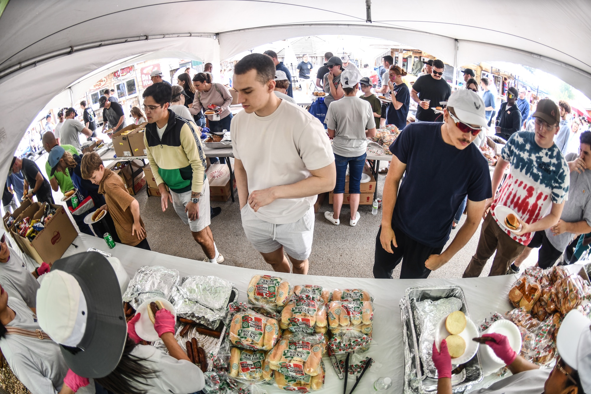 Service members and their families get food during Appreciation Day Picnic.
