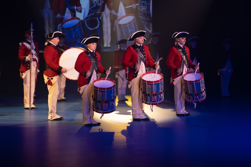 Fife and Drum Soldiers in Revolutionary War period uniforms stand in formation