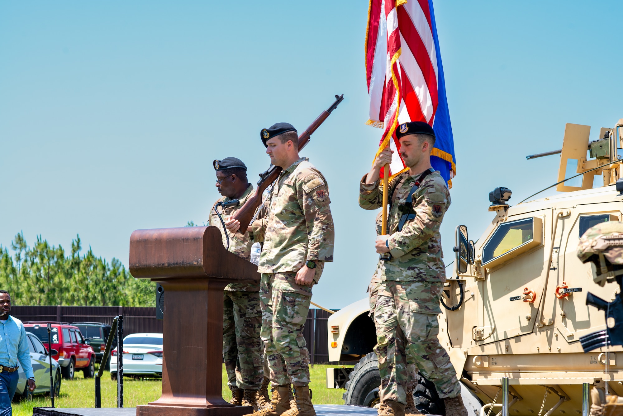 Three people standing on a stage.