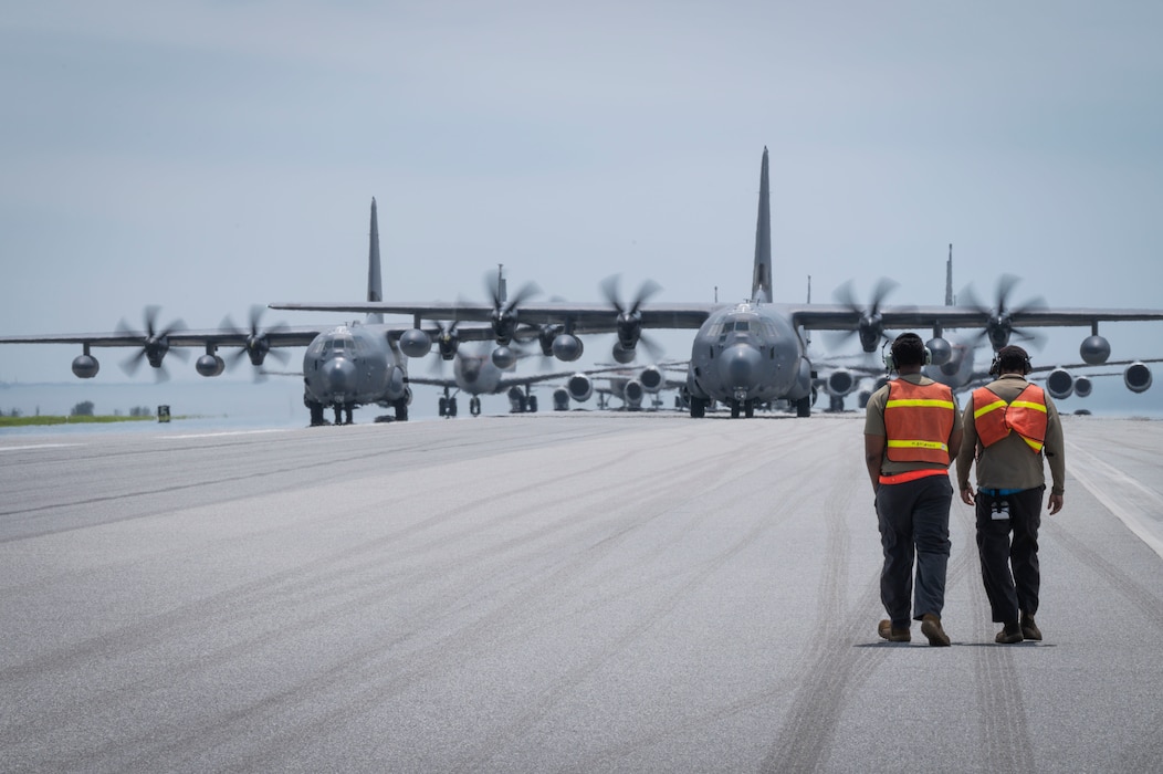 Airmen on a flightline walking towards airplanes
