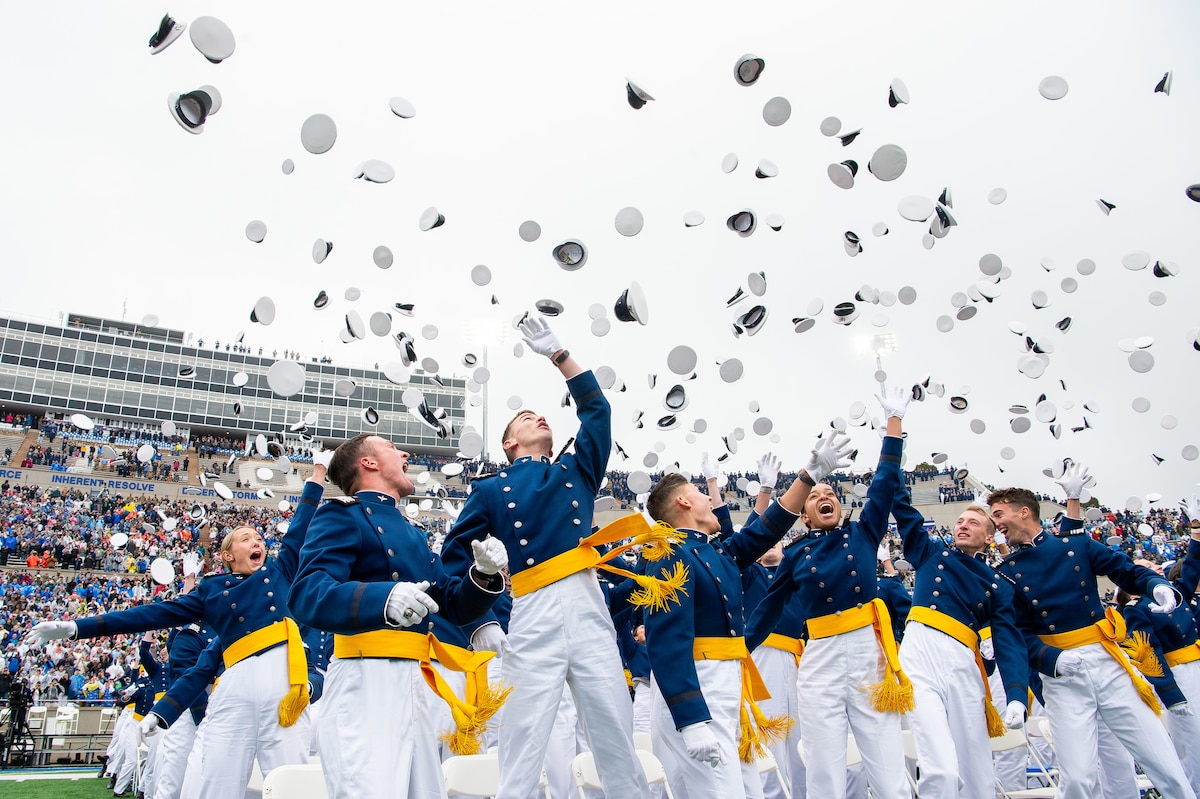 The U.S. Air Force Academy Class of 2025 graduates toss their hats skyward at Falcon Stadium in Colorado Springs, Colo., May 29, 2025. Nine hundred nine cadets received their commissions as second lieutenants in the Air Force and Space Force. (U.S. Air Force photo by Dylan Smith)