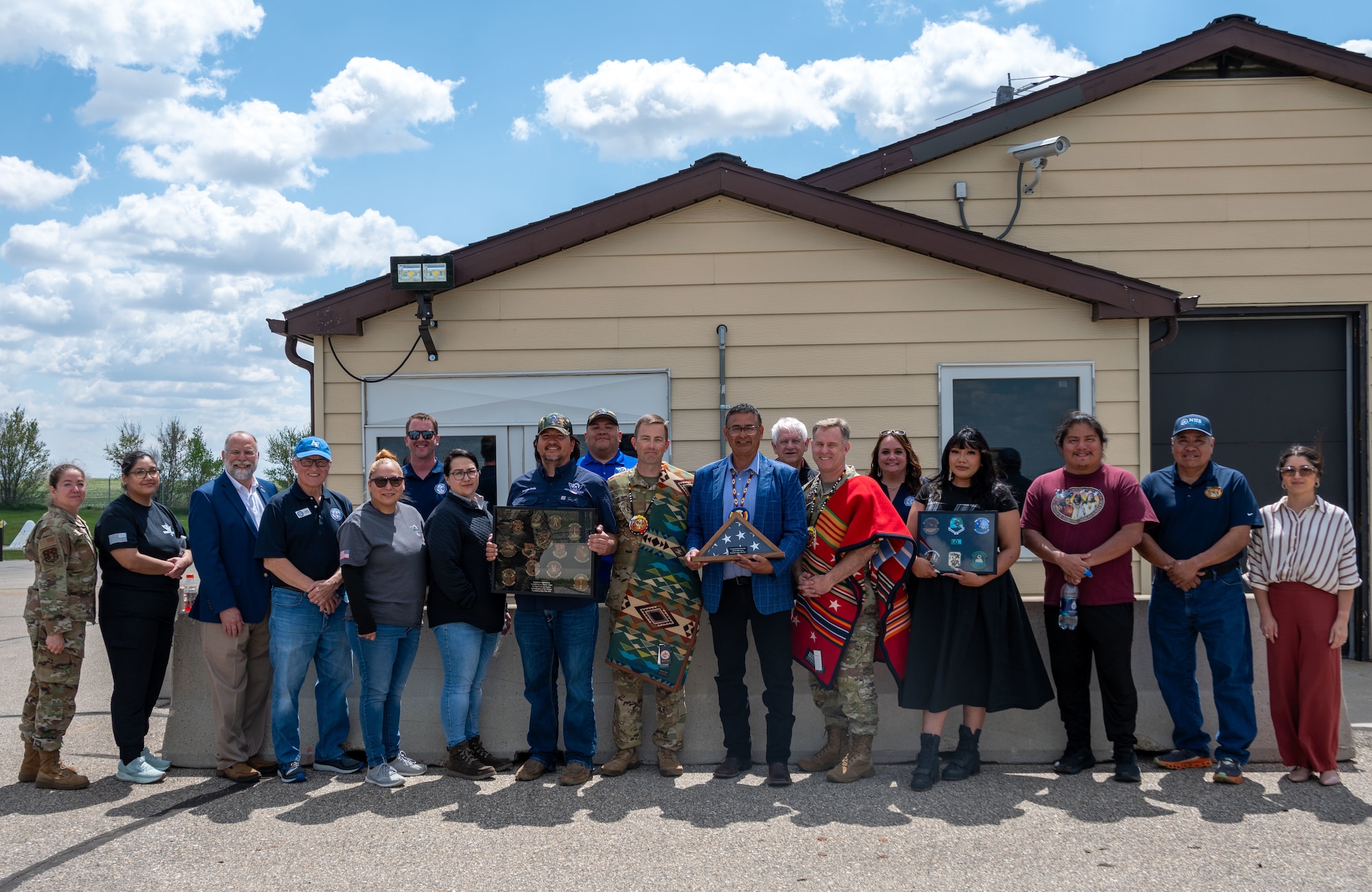 Members of the Mandan, Hidatsa and Arikara (MHA) Nation and 91st Missile Wing (MW) personnel pose for a group photo following a gift exchange at Missile Alert Facility H-01, at Minot Air Force Base, North Dakota, May 27, 2025. Mark Fox, chairman of the MHA Nation, presented traditional gifts to 91MW leadership as part of a cultural engagement to honor partnerships between Native American communities and the Department of Defense. (U.S. Air Force photo by Airman 1st Class Luis Gomez)