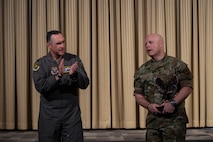 U.S. Air Force Col. Jesse Lamarand, 5th Bomb Wing commander (left), presents the Air Force Global Strike Command large team chaplain corps team of the year award to U.S. Air Force Lt. Col. Ronald Feeser, 5 BW chaplain (right), at Minot Air Force Base, North Dakota, May 28, 2025. Advising leadership on morale, religious, moral, ethical and spiritual issues falls under chaplains’ duties. (U.S. Air Force photo by Senior Airman Alyssa Bankston)