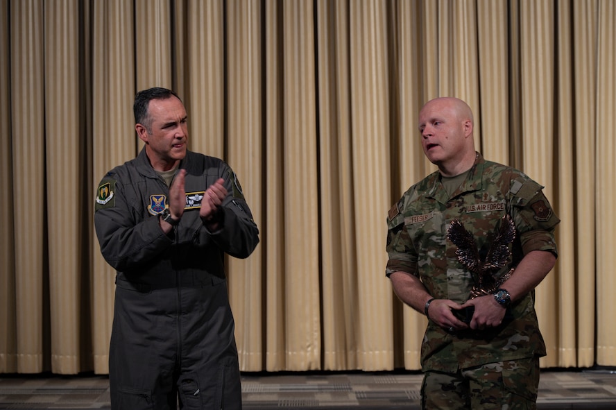 U.S. Air Force Col. Jesse Lamarand, 5th Bomb Wing commander (left), presents the Air Force Global Strike Command large team chaplain corps team of the year award to U.S. Air Force Lt. Col. Ronald Feeser, 5 BW chaplain (right), at Minot Air Force Base, North Dakota, May 28, 2025. Advising leadership on morale, religious, moral, ethical and spiritual issues falls under chaplains’ duties. (U.S. Air Force photo by Senior Airman Alyssa Bankston)