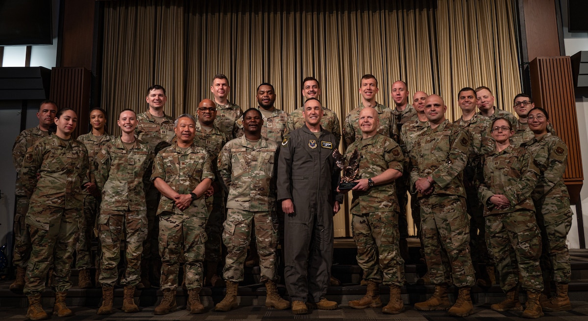 5th Bomb Wing command poses with Team Minot’s chaplains, winners of the Air Force Global Strike Command large team chaplain corps team of the year award at Minot Air Force Base, North Dakota, May 28, 2025. The chaplain corps lines of effort include fortifying warfighter readiness, reimaging chaplain culture and rebuilding chaplain readiness, on which the team award selections are based. (U.S. Air Force photo by Senior Airman Alyssa Bankston)
