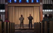 Chief Master Sgt. Wayne Sharp, 5th Bomb Wing (BW) command chief (left), and U.S. Air Force Col. Jesse Lamarand, 5 BW commander (right), address Team Minot’s chaplains, winners of the Air Force Global Strike Command large team chaplain corps team of the year award at Minot Air Force Base, North Dakota, May 28, 2025. Advising leadership on morale, religious, moral, ethical and spiritual issues falls under chaplains’ duties. (U.S. Air Force photo by Senior Airman Alyssa Bankston)