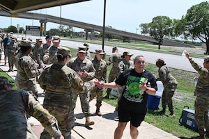 Frances Martinez, 960th CW director of psychological health, and other servicemembers arrives at the first rest station during the mental health awareness walk on JBSA-Lackland, Texas on May 3, 2025. (US Air Force photo by Alex Dieguez)