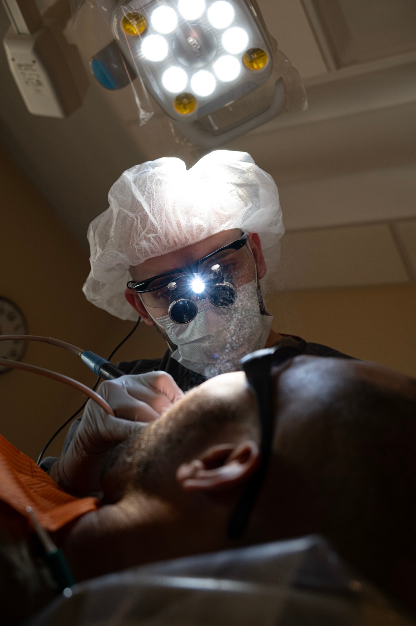Senior Airman Jose Vazquez-Vera, 5th Operational Medical Readiness Squadron (OMRS) oral preventive assistant technician, performs a dental cleaning during a routine dental appointment at Minot Air Force Base, North Dakota, May 28, 2025. To keep Airmen mission-ready, the 5OMRS dental flight works to provide service members with the best possible care. (U.S. Air Force photo by Senior Airman Alyssa Bankston)