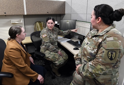 Army Reserve Staff Sgt. Aisha Harper, center, briefs Leigh Anne Alexander, left, director of U.S. Army Medical Logistics Command’s Integrated Logistics Support Center, on her work completed at AMLC as part of U.S. Army Communications-Electronic Command’s Detachment 7 program. DET 7, as it’s commonly known, supports CECOM units with reserve Soldiers who can complete their annual training requirements in functional commands, such as AMLC. Also pictured is Capt. Vanessa Vasquez, another DET 7 Soldier.