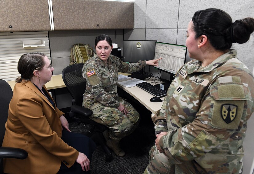 Army Reserve Staff Sgt. Aisha Harper, center, briefs Leigh Anne Alexander, left, director of U.S. Army Medical Logistics Command’s Integrated Logistics Support Center, on her work completed at AMLC as part of U.S. Army Communications-Electronic Command’s Detachment 7 program. DET 7, as it’s commonly known, supports CECOM units with reserve Soldiers who can complete their annual training requirements in functional commands, such as AMLC. Also pictured is Capt. Vanessa Vasquez, another DET 7 Soldier.