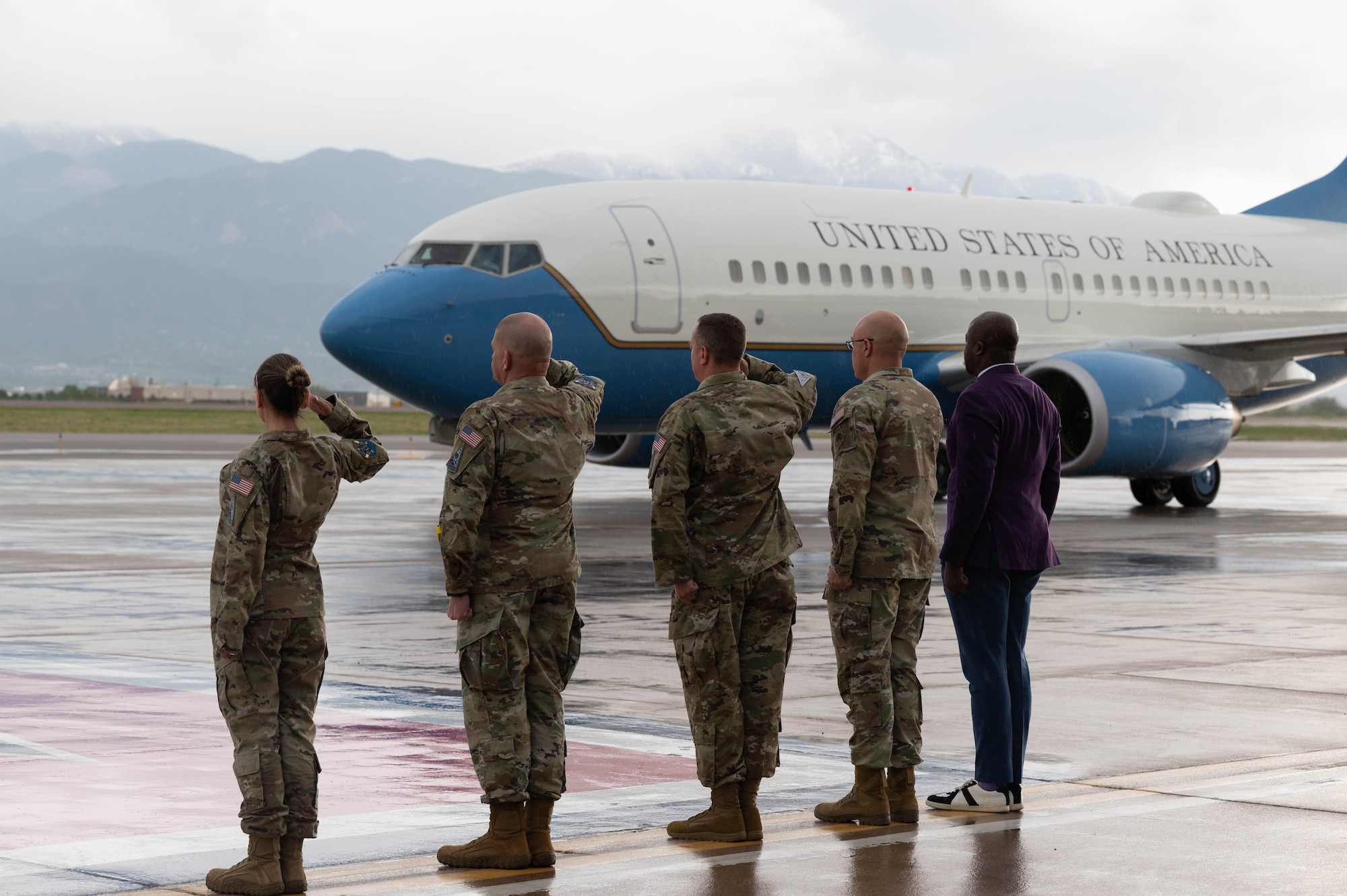 Leadership from Space Operations Command and Space Base Delta 1 salute the airplane with SECAF Troy Meink inside, alongside Colorado Springs Mayor Yemi Mobolade