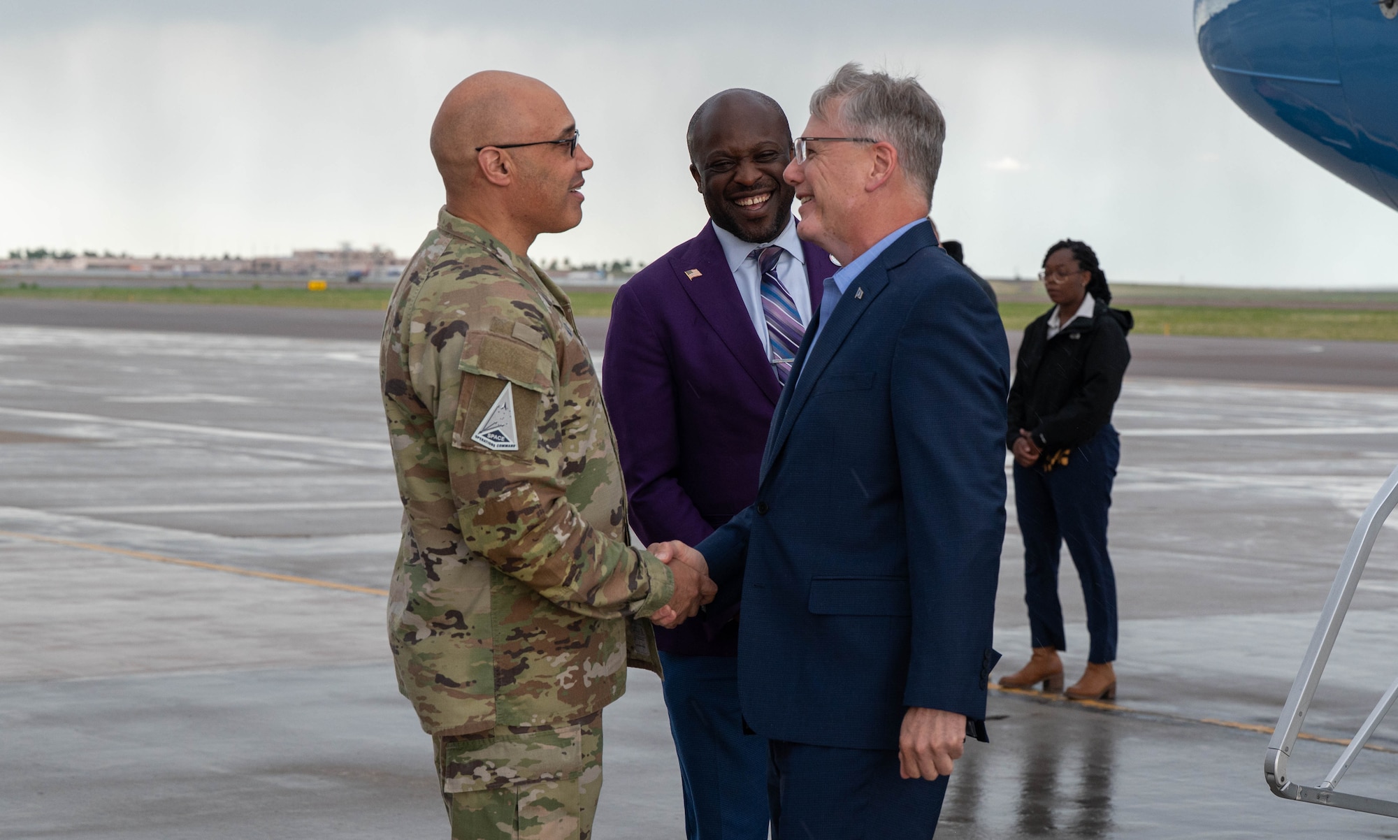 Secretary of the Air Force Troy Meink is greeted by U.S. Space Force Lt. Gen. David N. Miller Jr., Commander of Space Operations Command, with a handshake.