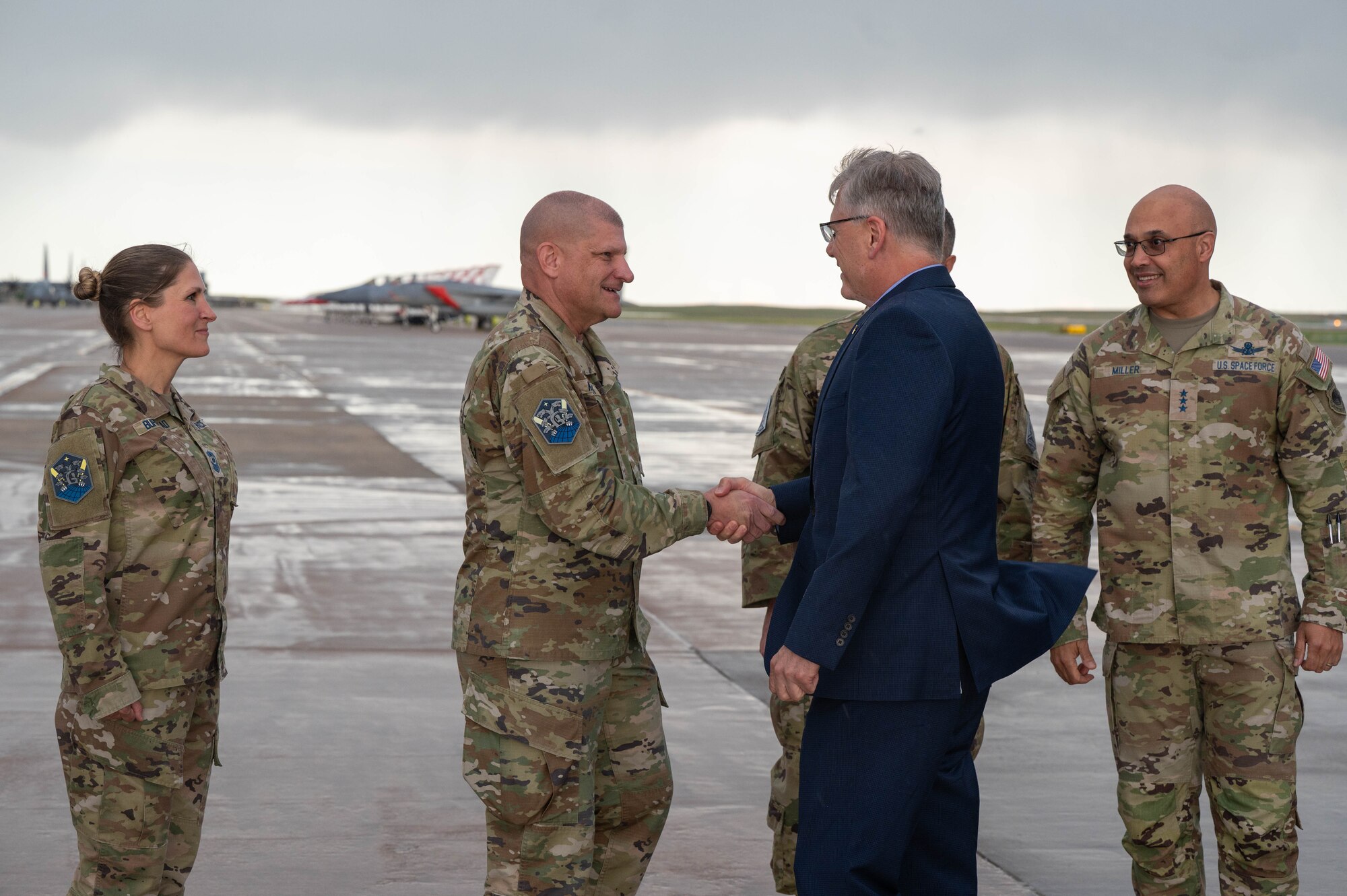 Secretary of the Air Force Troy Meink is greeted by U.S. Space Force Col. Kenneth Klock, Commander of Space Base Delta 1, with a handshake
