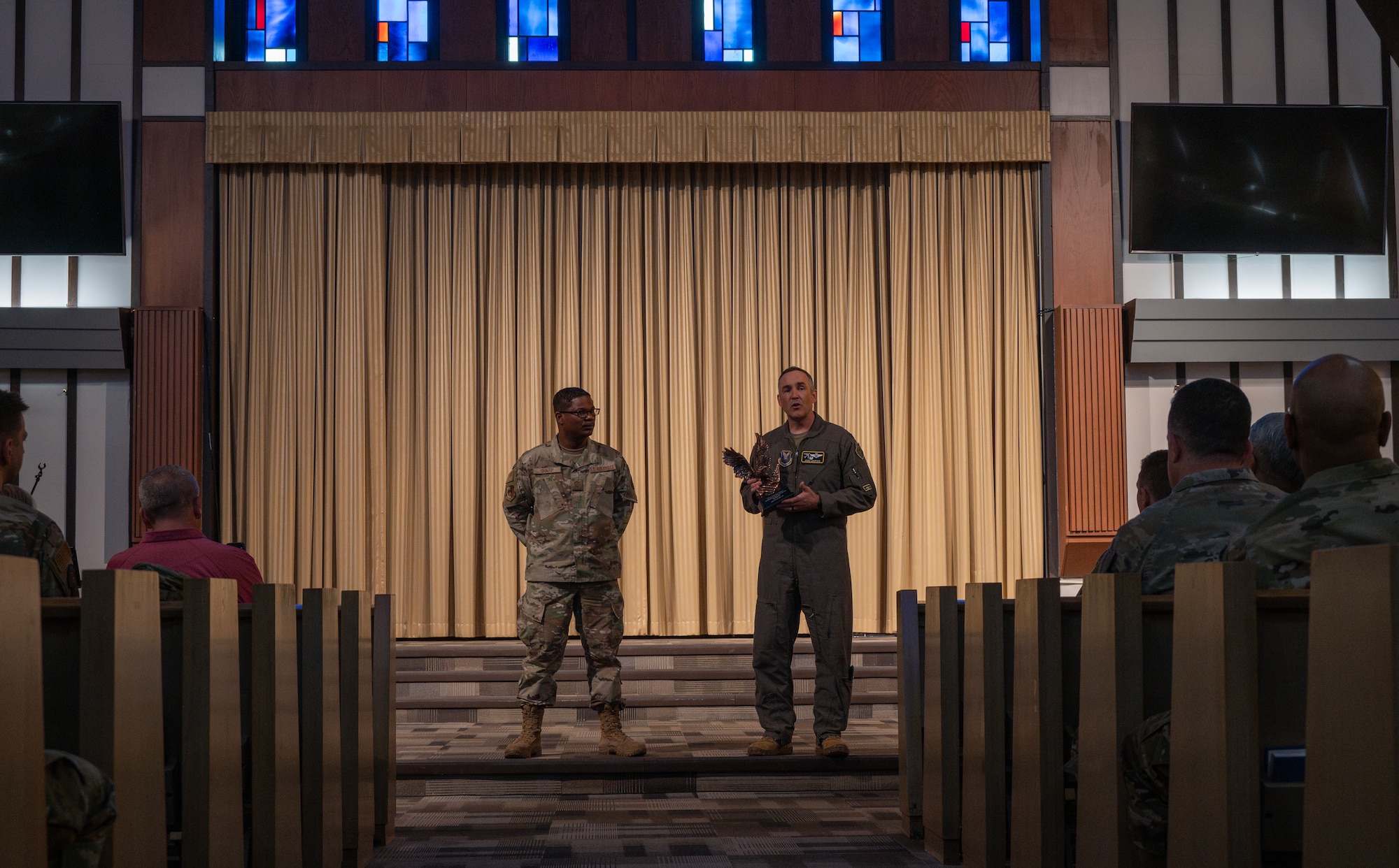 Chief Master Sgt. Wayne Sharp, 5th Bomb Wing (BW) command chief (left), and U.S. Air Force Col. Jesse Lamarand, 5 BW commander (right), address Team Minot’s chaplains, winners of the Air Force Global Strike Command large team chaplain corps team of the year award at Minot Air Force Base, North Dakota, May 28, 2025. Advising leadership on morale, religious, moral, ethical and spiritual issues falls under chaplains’ duties. (U.S. Air Force photo by Senior Airman Alyssa Bankston)