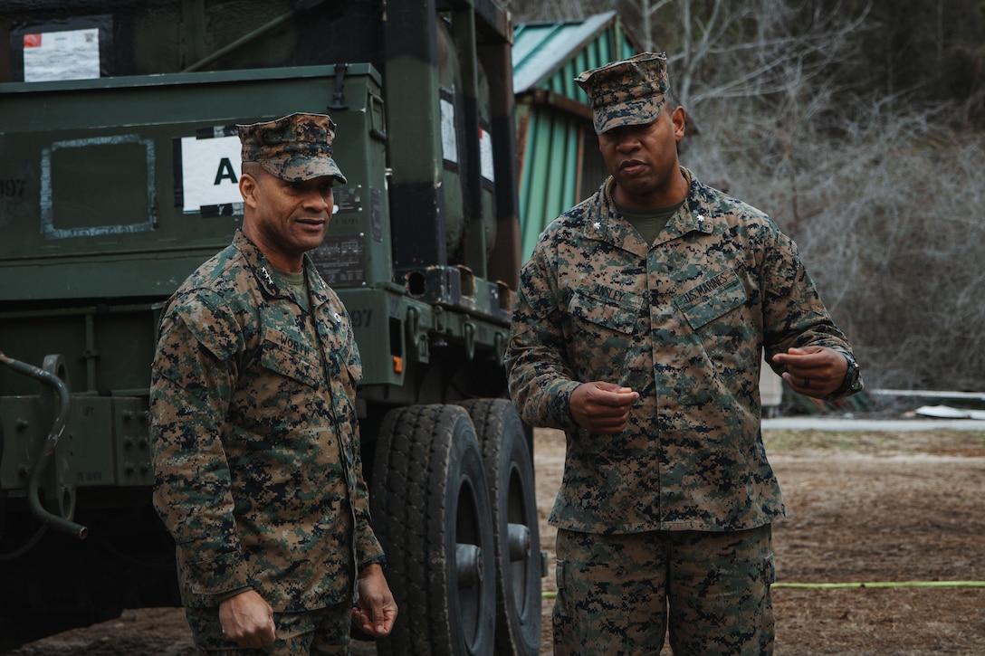 U.S. Marine Corps Lt. Gen. Calvert L. Worth, left, a Missouri native and commanding general of II Marine Expeditionary Force, and Lt. Col. Tony Ansley, right, a Florida native and commanding officer of Combat Logistics Battalion 22, speak about evacuation control center procedures during a noncombatant evacuation operation training mission conducted by the 26th Marine Expeditionary Unit at Auxiliary Landing Field Bogue, North Carolina, as part of a certification exercise Feb. 24, 2025. As the command element of a Marine Air-Ground Task Force, the 26th Marine Expeditionary Unit completed a certification exercise, conducted by Expeditionary Operations Training Group, to prepare for a diverse range of potential future missions, including personnel recovery, embassy reinforcement, foreign humanitarian assistance, and non-combatant evacuation operations. (U.S. Marine Corps photo by Sgt. Jorge Borjas)