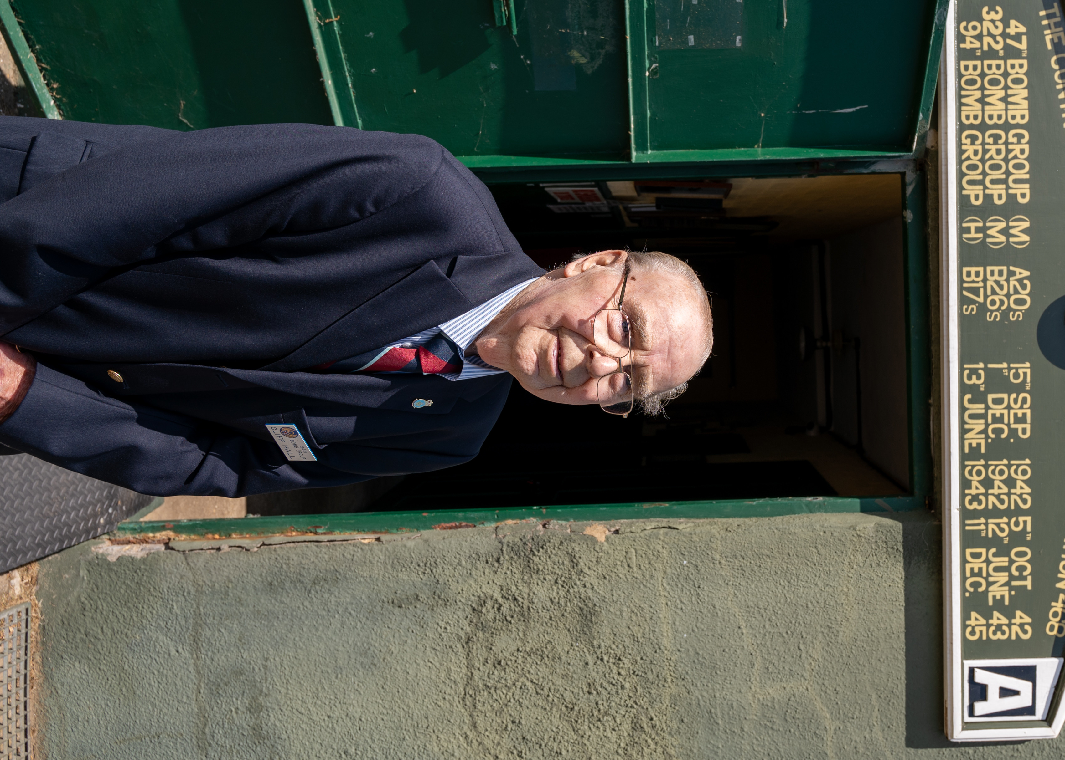 Cliff Hall stands outside the restored control tower of Rougham Control Tower Aviation Museum, Bury Saint Edmunds, United Kingdom, May 17, 2025. Hall grew up next to the airfield, befriending many Army Air Force members during World War II and shared stories and photographs of the 94th Bomb Group’s time in southern England. (U.S. Air Force photo by Capt. Casey D. Mull)