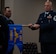 Senior Master Sgt. Jonathan Barron, Air Force Global Strike Command strategic deterrence and nuclear integration member, unwraps the new Detachment guidon at the Site Activation Task Force for Detachment 12. SATAF detachments are tasked with laying the groundwork for Sentinel support operations by overseeing and coordinating transition and establishment activities. (U.S. Air Force photo by Senior Airman Alexander Nottingham)