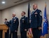 U.S. Air Force Gen. Thomas A. Bussiere, Air Force Global Strike Command commander, (left) prepares to present to Lt. Col. Nicholas Conover, Site Activation Task Force Detachment 12 commander, (middle) the Detachment 12 guidon at Minot Air Force Base, North Dakota, May 21, 2025. SATAF detachments are tasked with laying the groundwork for Sentinel support operations by overseeing and coordinating transition and deployment activities. (U.S. Air Force photo by Airman 1st Class Wesley Davies)