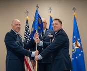U.S. Air Force Gen. Thomas A. Bussiere, Air Force Global Strike Command commander, (left) presents the Site Activation Task Force (SATAF) Detachment 12 guidon to U.S. Air Force Lt. Col. Nicholas Conover, SATAF Detachment 12 commander, for the detachment’s activation ceremony at Minot Air Force Base, North Dakota, May 21, 2025. The activation of SATAF Det. 12 marks an important step in preparing the base’s infrastructure to support the employment of the next-generation Sentinel Intercontinental Ballistic Missile system. (U.S. Air Force photo by Airman 1st Class Wesley Davies)
