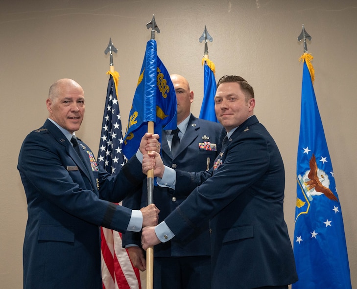 U.S. Air Force Gen. Thomas A. Bussiere, Air Force Global Strike Command commander, (left) presents the Site Activation Task Force (SATAF) Detachment 12 guidon to U.S. Air Force Lt. Col. Nicholas Conover, SATAF Detachment 12 commander, for the detachment’s activation ceremony at Minot Air Force Base, North Dakota, May 21, 2025. The activation of SATAF Det. 12 marks an important step in preparing the base’s infrastructure to support the employment of the next-generation Sentinel Intercontinental Ballistic Missile system. (U.S. Air Force photo by Airman 1st Class Wesley Davies)