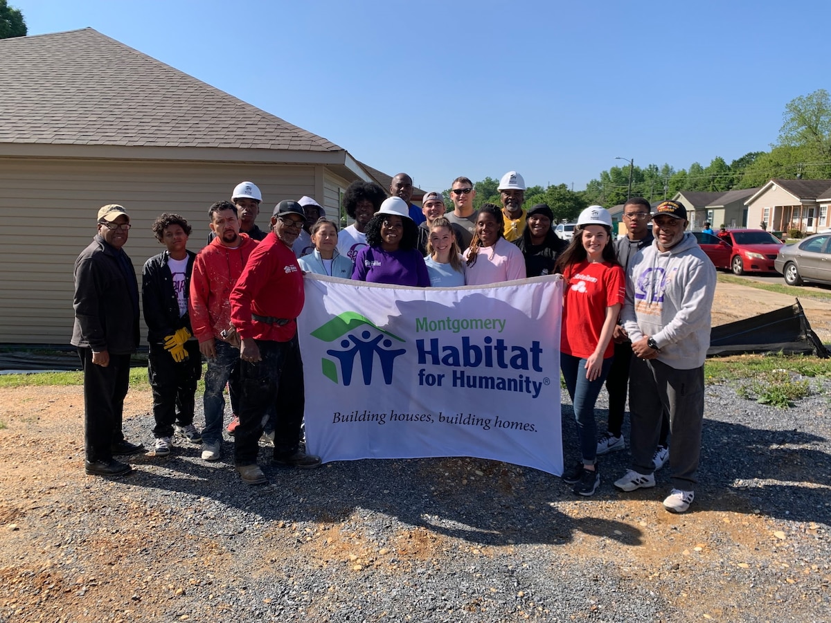 Civilians from the local community and U.S. Airmen from the 42nd Contracting Squadron pose for a group photo during a Habitat for Humanity build in Montgomery, Alabama, April 12, 2025.
