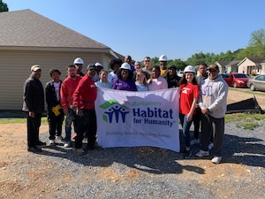 Civilians from the local community and U.S. Airmen from the 42nd Contracting Squadron pose for a group photo during a Habitat for Humanity build in Montgomery, Alabama, April 12, 2025.