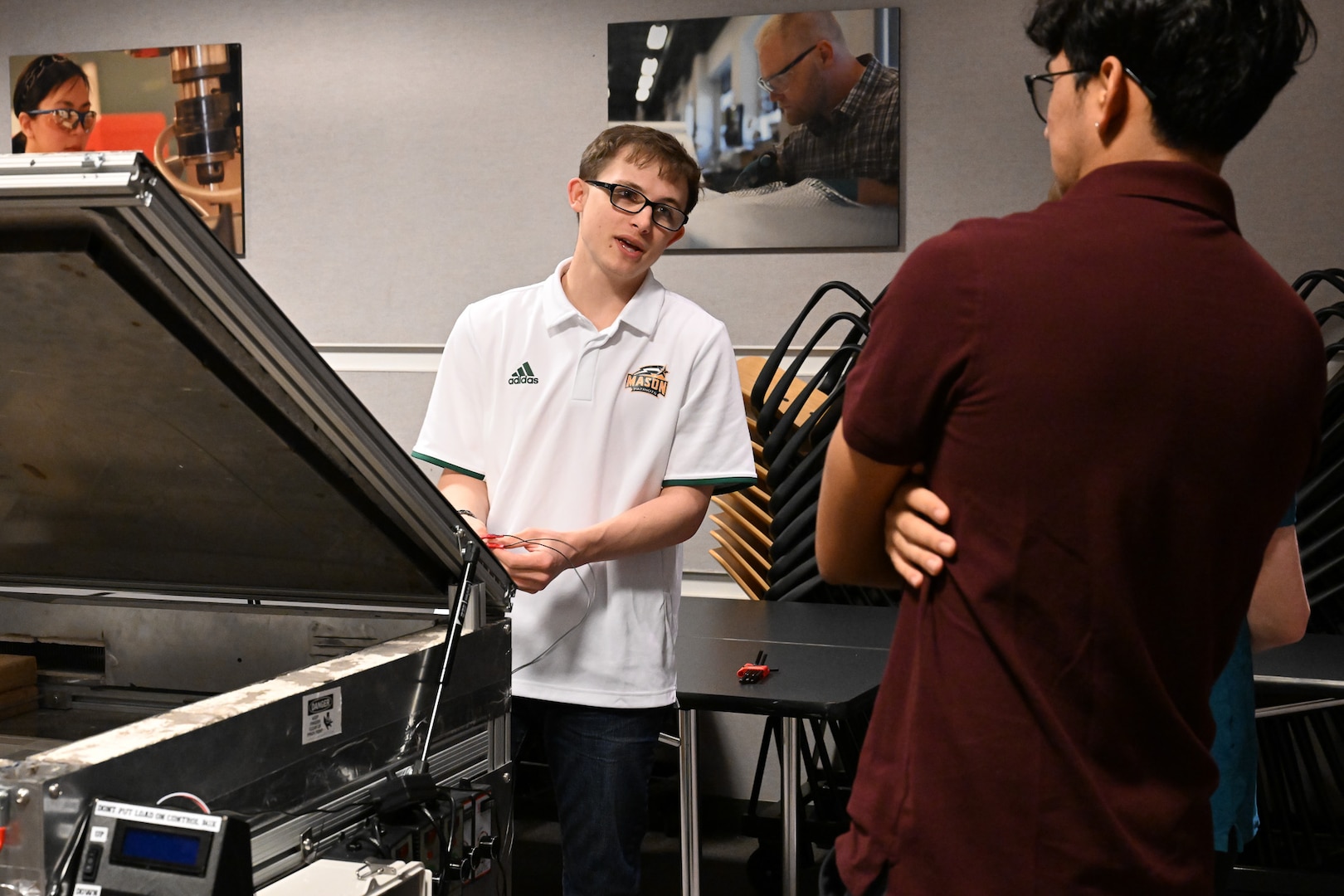 Seniors from George Mason University visited Naval Surface Warfare Center, Carderock Division, to present their senior design projects to Carderock engineers on May 9, 2024. The two teams presented their projects; one team built an environmental chamber for mechanical testing and the other was tasked with fabricating composite panels for ready service lockers that were malleable enough to bend 45 degrees on all four corners and edges. Carderock, the Navy's ship design and innovation powerhouse, provides the technical foundation for the future fleet through world-class research, development, and testing. (U.S. Navy Photo by Chalene Simmons)