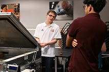 Seniors from George Mason University visited Naval Surface Warfare Center, Carderock Division, to present their senior design projects to Carderock engineers on May 9, 2024. The two teams presented their projects; one team built an environmental chamber for mechanical testing and the other was tasked with fabricating composite panels for ready service lockers that were malleable enough to bend 45 degrees on all four corners and edges. Carderock, the Navy's ship design and innovation powerhouse, provides the technical foundation for the future fleet through world-class research, development, and testing. (U.S. Navy Photo by Chalene Simmons)