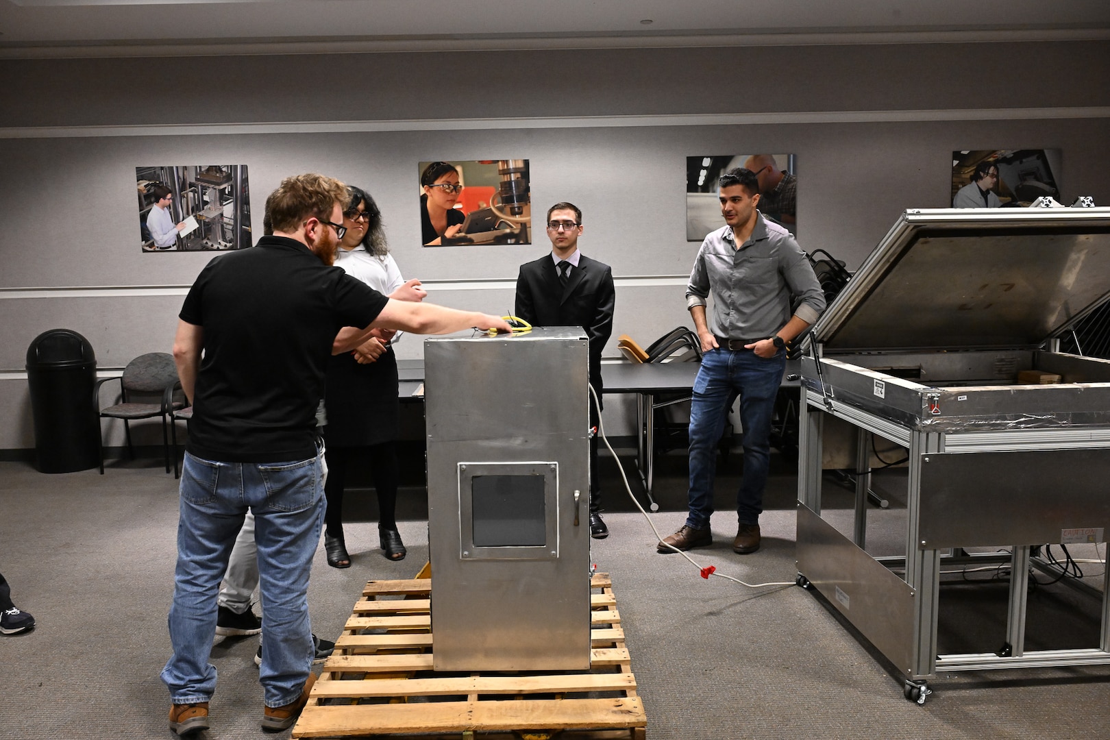Seniors from George Mason University visited Naval Surface Warfare Center, Carderock Division, to present their senior design projects to Carderock engineers on May 9, 2024. The two teams presented their projects; one team built an environmental chamber for mechanical testing and the other was tasked with fabricating composite panels for ready service lockers that were malleable enough to bend 45 degrees on all four corners and edges. Carderock, the Navy's ship design and innovation powerhouse, provides the technical foundation for the future fleet through world-class research, development, and testing. (U.S. Navy Photo by Chalene Simmons)